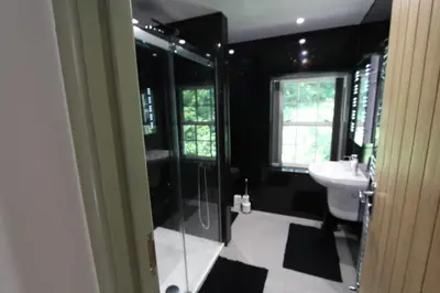 a bathroom with a glass shower and a sink at Rhydyfran House Aberaeron, Lampeter, West Wales, Ceredigion in Lampeter