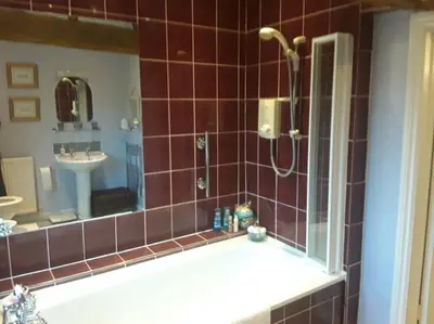 a bathroom with a shower and a bath tub at THE RETREAT in Hereford