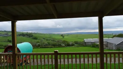 a view of a field from a porch at Woodbatch Camping & Glamping in Bishops Castle