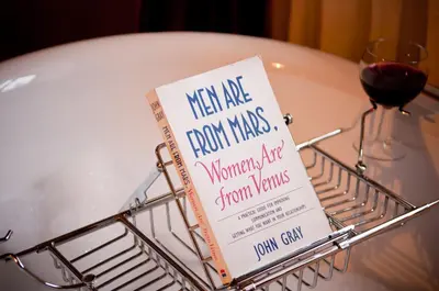 a book in a basket on a table with a glass of wine at Walford Court in Leintwardine