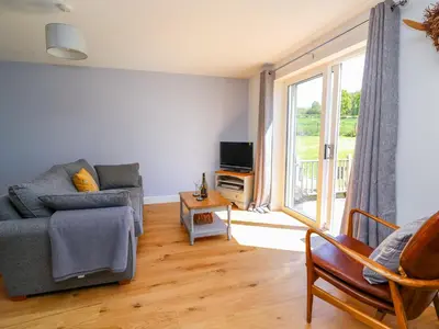 a living room with a couch and a tv at Owl Cottage in Llandrindod Wells