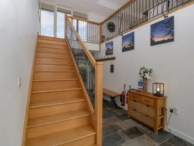 a wooden staircase in a home with a desk at The Dutch Barn in Leominster