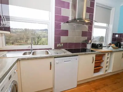 a kitchen with a sink and a window at Ty'r Orsaf in Builth Wells