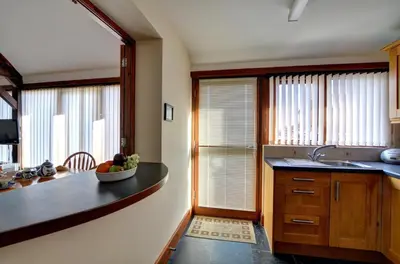 a kitchen with a counter with a bowl of fruit on it at 2 Bed in Welshpool oc-wab256 in Berriew