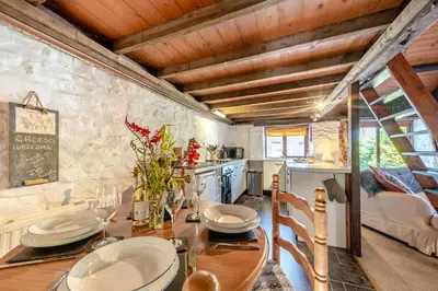 a dining room with a table and a kitchen at 2 Bed in Llandeilo oc-waw313 in Talley