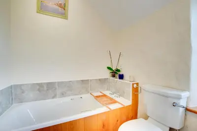a bathroom with a bath tub and a toilet at 3 Bed in Dolgellau oc-wah464 in Llanfachreth