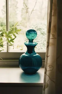 a blue vase sitting on a window sill at Courtyard Cottage in Oswestry