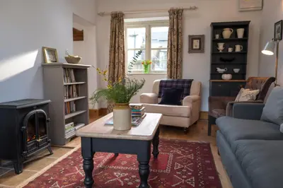 a living room with a couch and a coffee table at Courtyard Cottage in Oswestry