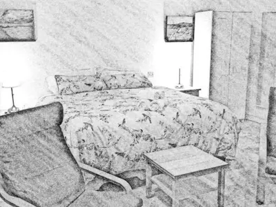 a bedroom with a bed and a chair and a table at Garden Room near Brecon in Brecon
