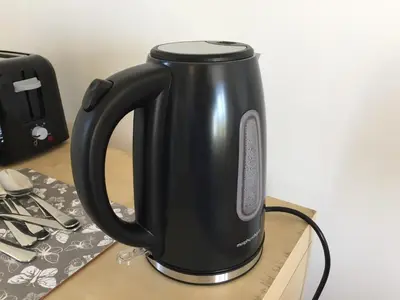 a black kettle sitting on top of a table at Garden Room near Brecon in Brecon
