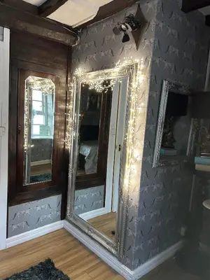 a room with two mirrors on the wall at 8 Opera Suites, Llangollen in Llangollen