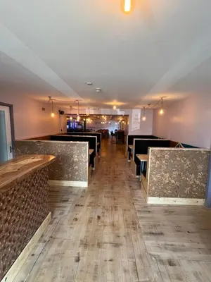 a dining room with a row of tables and chairs at Hampton Hotel & restaurant in Llandrindod Wells