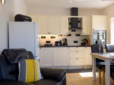 a kitchen with a couch and a white refrigerator at Windhover in Glasbury