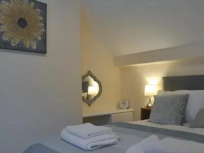 a bedroom with a bed with towels on it at Pen Parc in Bryn-crug