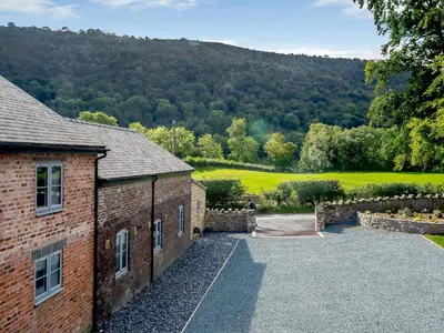 an exterior view of a brick building with a driveway at Ty Felin - Uk12744 in Acrefair