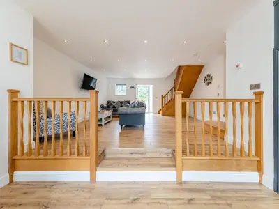 a view of the living room and staircase in a house at Y Stabl - Uk12742 in Acrefair