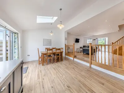 an open kitchen and dining room with a table and chairs at Y Stabl - Uk12742 in Acrefair
