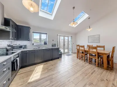 a kitchen with a table and a dining room at Y Stabl - Uk12742 in Acrefair