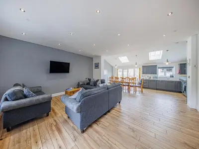 a living room with two couches and a kitchen at Cor Tarw - Uk12743 in Acrefair