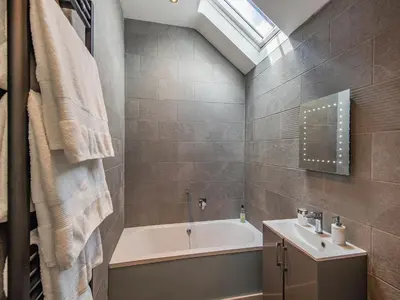 a bathroom with a bath tub and a sink at Cor Tarw - Uk12743 in Acrefair