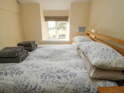a bedroom with two beds and a window at Little Bicton in Craven Arms