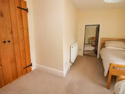 a bedroom with a bed and a mirror at Little Bicton in Craven Arms