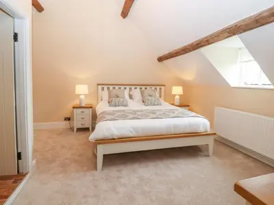 a bedroom with a large bed and a window at Rhandregynwen Hall in Llanymynech