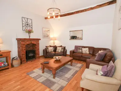 a living room with a couch and a fireplace at Old Hall Barn 3 in Church Stretton