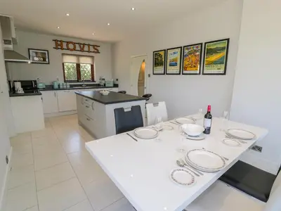 a kitchen with a white table with plates on it at Berwyn in Talybont