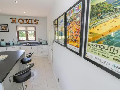 a kitchen with large posters on the wall at Berwyn in Talybont