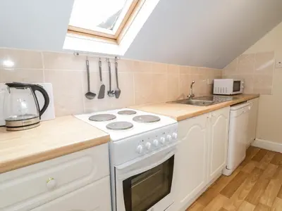 a kitchen with a white stove and a sink at Abermaw Views in Barmouth