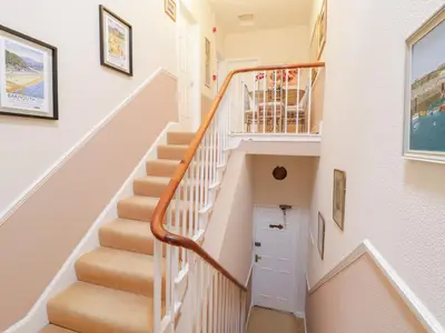a staircase in a home with white walls at Abermaw Views in Barmouth
