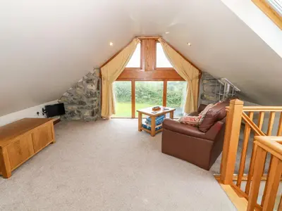 a living room with a couch and a window at Dysynni in Tywyn