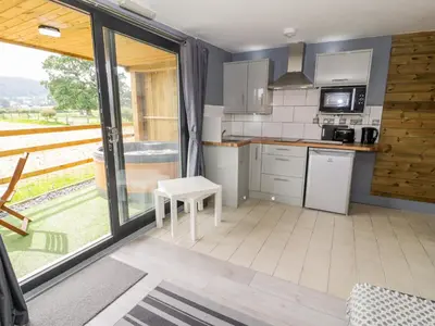 a small kitchen with a view of a yard at Cilan Lodge in Corwen