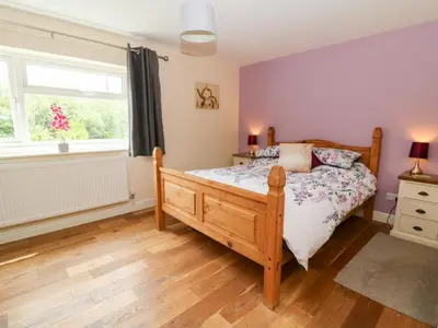 a bedroom with a bed and a window at New Peny in Llandrindod Wells