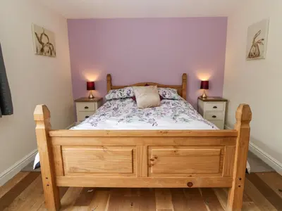 a bedroom with a wooden bed with two night stands at New Peny in Llandrindod Wells