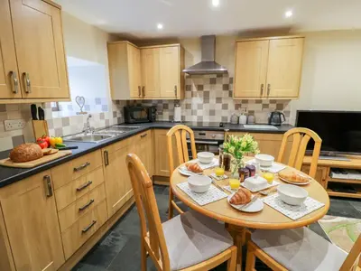a kitchen with a wooden table with food on it at Yr Hen Stabal in Blaenau-Ffestiniog