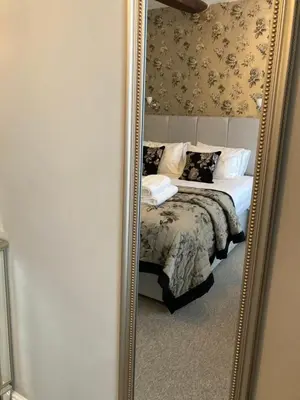 a mirror reflection of a bed in a bedroom at Assembly View - two bedroomed apartment with parking permit in Ludlow Town Centre in Ludlow