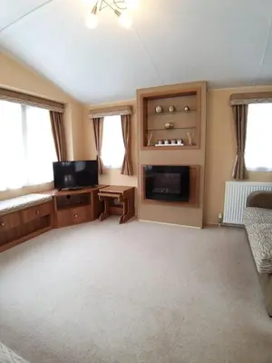 a living room with a flat screen tv and a couch at Clwyd 6 in Borth