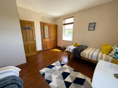 a living room with two beds and a window at Cliff haven in Borth