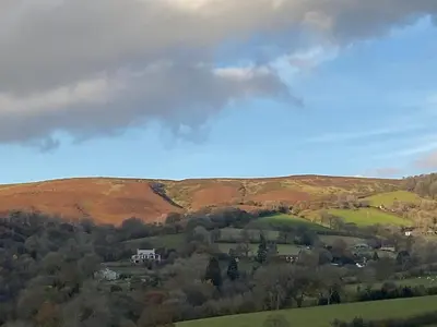 a view of a valley with houses and trees at RedWood Lodge in Ludlow