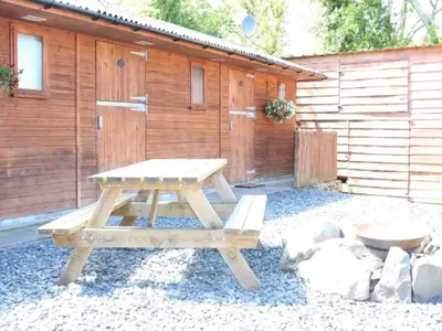 a picnic table in front of a cabin at Private Heated Bedrooms at The Bunkhouse in Snowdonia Perfect for Bikers and Walkers in Dolgellau