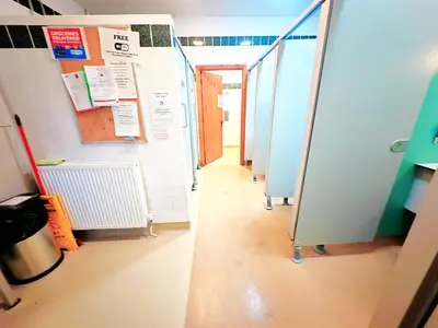 a row of stalls in a hallway in a bathroom at Private Heated Bedrooms at The Bunkhouse in Snowdonia Perfect for Bikers and Walkers in Dolgellau