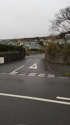 an empty street with an arrow on the road at Hendre Coed Isaf static caravan Barmouth in Barmouth