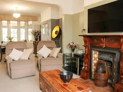 a living room with a fireplace and a tv at Sunningdale in Ludlow