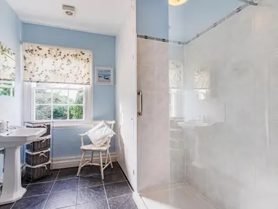 a bathroom with a shower and a sink and a toilet at Riverside in Craven Arms