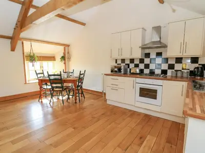 a kitchen and dining room with a table and chairs at The Stable in Lampeter