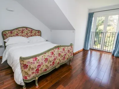 a bedroom with a bed with a floral bed frame at The Pheasantry in Builth Wells