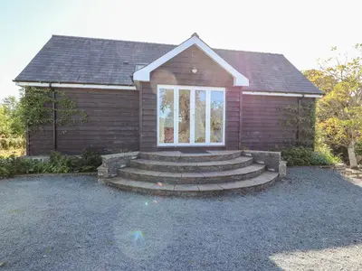a small house with stairs in front of it at The Pheasantry in Builth Wells