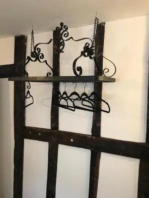 a wrought iron shelf hanging on a wall at 